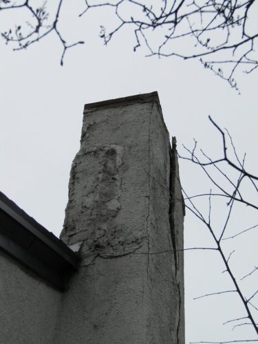 Major damage at stucco-covered chimney